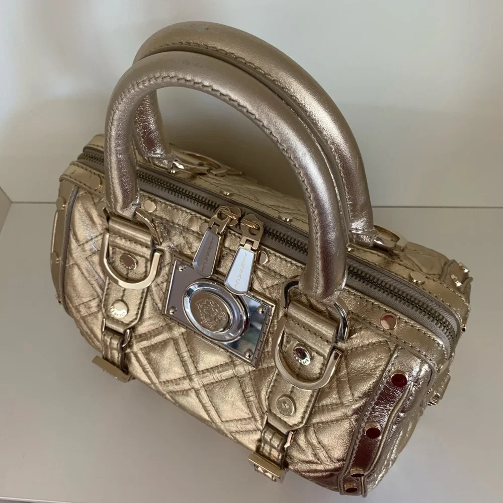 Hold Versace gold quilted handbag